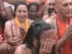 Hema Malini couldn't help but laugh as Swami Ramdev flipped his long hair in diva style at the Mahakumbh. Hema Malini couldn't help but laugh as Swami Ramdev flipped his long hair in diva style at the Mahakumbh.