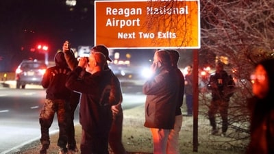 The aircraft was carrying four crew members and 60 passengers, while the helicopter was reportedly a US Army Black Hawk. In the image: Onlookers observe as emergency teams respond to the scene near the Potomac River. (Bloomberg/ Alex Wroblewski/) The aircraft was carrying four crew members and 60 passengers, while the helicopter was reportedly a US Army Black Hawk. In the image: Onlookers observe as emergency teams respond to the scene near the Potomac River. (Bloomberg/ Alex Wroblewski/)