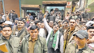 Former AAP councillor and AIMIM candidate Tahir Hussain during his election campaign in Mustafabad under police custody on Wednesday. (Arvind Yadav/HT PHOTO)