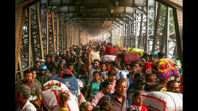 Pilgrims walk along the old Yamuna bridge in Prayagraj . (AFP) Pilgrims walk along the old Yamuna bridge in Prayagraj . (AFP)