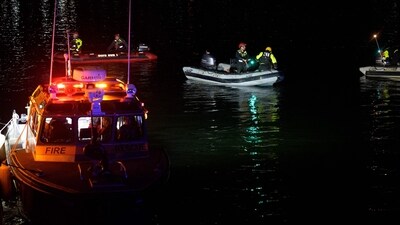 An emergency response team with Washington, DC Fire and EMS make their way to airplane wreckage in the Potomac River near Ronald Reagan Washington Airport on January 30, 2025 in Arlington, Virginia. An American Airlines flight from Wichita, Kansas collided with a helicopter while approaching Ronald Reagan National Airport. (Photo by Andrew Harnik / GETTY IMAGES NORTH AMERICA / Getty Images via AFP) (Getty Images via AFP)