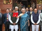 Nirmala Sitharaman leaves the Finance Ministry carrying the Finance Budget ahead of the presentation of Budget 2024 in Parliament at North Block in New Delhi.