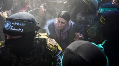 29-year-old Arbel Yehoud was escorted by Hamas and Islamic Jihad fighters and handed over to the Red Cross in Khan Younis (AP) 29-year-old Arbel Yehoud was escorted by Hamas and Islamic Jihad fighters and handed over to the Red Cross in Khan Younis (AP)
