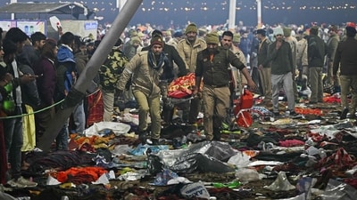 Security personnel carry an injured pilgrim at the site of a stampede amid the ongoing Maha Kumbh Mela festival in Prayagraj. (Arun Sankar/AFP) Security personnel carry an injured pilgrim at the site of a stampede amid the ongoing Maha Kumbh Mela festival in Prayagraj. (Arun Sankar/AFP)