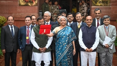 Nirmala Sitharaman presented the 2024 Union Budget in a blue saree with swirling floral motifs in white. She wore a cream-coloured blouse to colour-coordinate with the floral motifs in the saree. (HT_PRINT) Nirmala Sitharaman presented the 2024 Union Budget in a blue saree with swirling floral motifs in white. She wore a cream-coloured blouse to colour-coordinate with the floral motifs in the saree. (HT_PRINT)