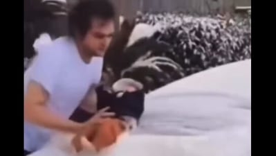 A viral TikTok video featured a man using a baby to clean snow off his car, triggering widespread outrage. (X/@Bubblebathgirl) A viral TikTok video featured a man using a baby to clean snow off his car, triggering widespread outrage. (X/@Bubblebathgirl)