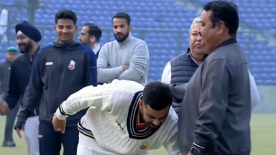 Virat Kohli touches childhood coach Rajkumar Sharma's feet Virat Kohli touches childhood coach Rajkumar Sharma's feet