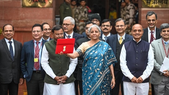 Nirmala Sitharaman leaves the Finance Ministry carrying the Finance Budget ahead of the presentation of Budget 2024 in Parliament at North Block in New Delhi. (PTI File)