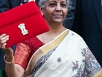 Union Finance Minister Nirmala Sitharaman shows the Budget Tablet as she arrives at Parliament House to present the Union Budget 2025.