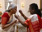 President Droupadi Murmu offers auspicious dahi 'cheeni' to Union Finance Minister Nirmala Sitharaman during a meeting before the latter presents the Budget 2025-26, at the Rashtrapati Bhavan in New Delhi. 