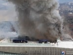 Fire engines are seen on a road as smoke rises from the roof of the National Hangeul Museum in Seoul on February 1, 2025. (Photo by YONHAP / AFP) / - South Korea OUT / NO ARCHIVE / REPUBLIC OF KOREA OUT / NO ARCHIVES - RESTRICTED TO SUBSCRIPTION USE Fire engines are seen on a road as smoke rises from the roof of the National Hangeul Museum in Seoul on February 1, 2025. (Photo by YONHAP / AFP) / - South Korea OUT / NO ARCHIVE / REPUBLIC OF KOREA OUT / NO ARCHIVES - RESTRICTED TO SUBSCRIPTION USE