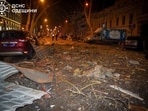 Debris is scattered across the road at the site of a Russian strike on Ukraine