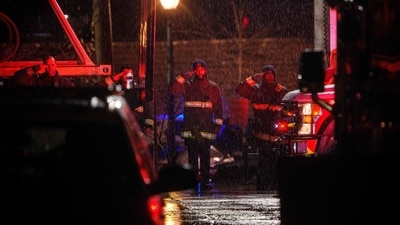 First responders salute as two ambulances carrying the flag draped bodies of service members killed in a midair collision depart a temporary emergency disaster site at Buzzard Point on January 31, 2025 in Washington, DC. (Getty Images via AFP)