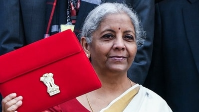 Union Finance Minister Nirmala Sitharaman shows the Budget Tablet as she arrives at Parliament House to present the Union Budget 2025. (ANI) Union Finance Minister Nirmala Sitharaman shows the Budget Tablet as she arrives at Parliament House to present the Union Budget 2025. (ANI)