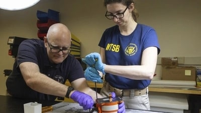 In Washington, investigators from the National Transportation Safety Board on January 30 inspect the flight data recorder and cockpit voice recorder that were recovered from the American Airlines passenger plane that collided with an Army helicopter on Wednesday night close to Ronald Reagan Washington National Airport. (AP) In Washington, investigators from the National Transportation Safety Board on January 30 inspect the flight data recorder and cockpit voice recorder that were recovered from the American Airlines passenger plane that collided with an Army helicopter on Wednesday night close to Ronald Reagan Washington National Airport. (AP)