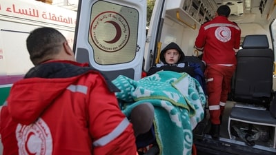 A Palestinian girl, who was also injured in the Israeli bombardment of the Gaza Strip, was being carried by medics before Rafah border crossing in Egypt. Sick and wounded Palestinians are now allowed to leave Gaza Strip for treatment and medical attention. (AP) A Palestinian girl, who was also injured in the Israeli bombardment of the Gaza Strip, was being carried by medics before Rafah border crossing in Egypt. Sick and wounded Palestinians are now allowed to leave Gaza Strip for treatment and medical attention. (AP)