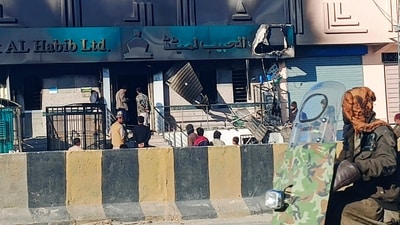 Commuters ride past a bank set ablaze by militants at Kalat district, in Pakistan's Balochistan province on February 1, 2025. Eighteen paramilitaries were killed and three others seriously wounded in an attack in Pakistan's southwest Balochistan province, police and the military said on February 1. (Photo by AFP) (AFP) Commuters ride past a bank set ablaze by militants at Kalat district, in Pakistan's Balochistan province on February 1, 2025. Eighteen paramilitaries were killed and three others seriously wounded in an attack in Pakistan's southwest Balochistan province, police and the military said on February 1. (Photo by AFP) (AFP)