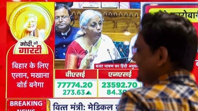A man watches finance minister Nirmala Sitharaman presenting the Union Budget 2025-26 on television screens at a showroom, in Patna, Saturday, (PTI) A man watches finance minister Nirmala Sitharaman presenting the Union Budget 2025-26 on television screens at a showroom, in Patna, Saturday, (PTI)