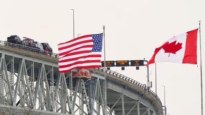 The US and Canadian flags fly on the US side of the St. Clair River near the Bluewater Bridge border crossing between Sarnia, Ontario and Port Huron, Michigan on January 29. (AFP) The US and Canadian flags fly on the US side of the St. Clair River near the Bluewater Bridge border crossing between Sarnia, Ontario and Port Huron, Michigan on January 29. (AFP)