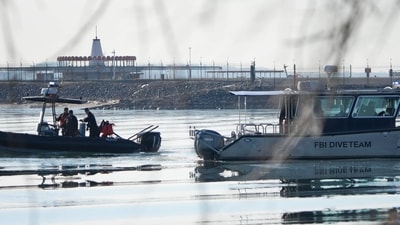 Washington DC plane crash: Emergency response units search near the crash site of an American Airlines plane on the Potomac River after an accident. (AFP) Washington DC plane crash: Emergency response units search near the crash site of an American Airlines plane on the Potomac River after an accident. (AFP)