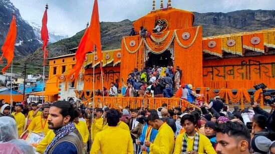 Devotees arrive at the Shri Badrinath temple after its portals were opened in Chamoli district on Sunday morning. (PTI)