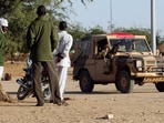 (FILES) Chadians look at French military vehicles driving on a trail near Abeche (Eastern Chad), 15 November 2007. The French army partols and secures the western part of Darfur border in Chad. European Union will send soon almost 4,300 soldiers to secure the refugees camps in Chad where around 400,000 refugees and displaced Chadians are gathered. Chad announced on November 28, 2024 that it was ending military cooperation with former colonial power France, just hours after a visit by French Foreign Minister Jean-Noel Barrot. Chad is a key link in France's military presence in Africa, constituting Paris's last foothold in the Sahel after the forced withdrawal of its troops from Mali, Burkina Faso and Niger. (Photo by Thomas COEX / AFP)