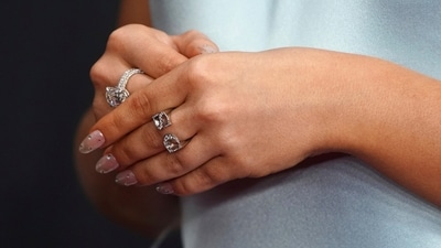 Sabrina's jewellery choices perfectly complemented her baby blue, feather-trimmed backless gown from JW Anderson, which was a nod to Old Hollywood glamour. She also wore a ring showcasing with her initials: S and C. (AP) Sabrina's jewellery choices perfectly complemented her baby blue, feather-trimmed backless gown from JW Anderson, which was a nod to Old Hollywood glamour. She also wore a ring showcasing with her initials: S and C. (AP)