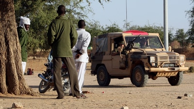(FILES) Chadians look at French military vehicles driving on a trail near Abeche (Eastern Chad), 15 November 2007. The French army partols and secures the western part of Darfur border in Chad. European Union will send soon almost 4,300 soldiers to secure the refugees camps in Chad where around 400,000 refugees and displaced Chadians are gathered. Chad announced on November 28, 2024 that it was ending military cooperation with former colonial power France, just hours after a visit by French Foreign Minister Jean-Noel Barrot. Chad is a key link in France's military presence in Africa, constituting Paris's last foothold in the Sahel after the forced withdrawal of its troops from Mali, Burkina Faso and Niger. (Photo by Thomas COEX / AFP) (AFP) (FILES) Chadians look at French military vehicles driving on a trail near Abeche (Eastern Chad), 15 November 2007. The French army partols and secures the western part of Darfur border in Chad. European Union will send soon almost 4,300 soldiers to secure the refugees camps in Chad where around 400,000 refugees and displaced Chadians are gathered. Chad announced on November 28, 2024 that it was ending military cooperation with former colonial power France, just hours after a visit by French Foreign Minister Jean-Noel Barrot. Chad is a key link in France's military presence in Africa, constituting Paris's last foothold in the Sahel after the forced withdrawal of its troops from Mali, Burkina Faso and Niger. (Photo by Thomas COEX / AFP) (AFP)