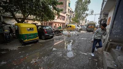 Garbage spilled in the open, along with puddles on the broken road patch, in Bhikam Singh Colony. (Sanchit Khanna/HT Photo) Garbage spilled in the open, along with puddles on the broken road patch, in Bhikam Singh Colony. (Sanchit Khanna/HT Photo)