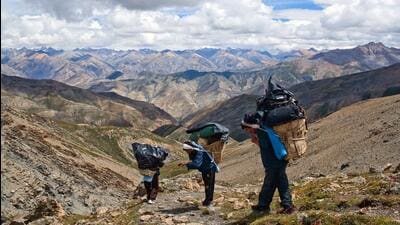 Nepalese porters walk across the Shey La Pass in Dolpo region of the Himalayas. (Getty Images)