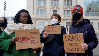 People hold placards outside the USAID building after billionaire Elon Musk, who is heading U.S. President Donald Trump's drive to shrink the federal government, said work is underway to shut down the U.S. foreign aid agency USAID, in Washington, US on February 3, 2025. (REUTERS)