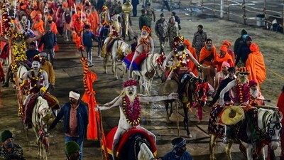 Naga Sadhus led most of the akharas during the sacred bathing ritual on Basant Panchami, displaying their weapon-handling skills by wielding spears, swords and tridents with precision. Some Naga sadhus were seen riding horses, while others walked barefoot with garlands draped around their necks and tridents held high. (Deepak Gupta/Hindustan Times)