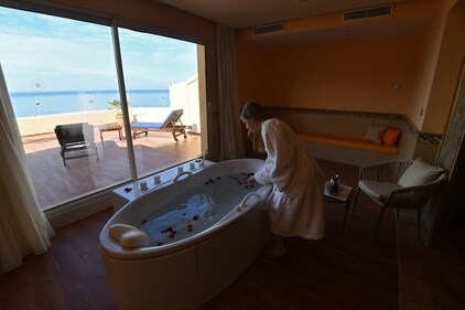 A woman enjoys a relaxing time at the spa in Korbous, in Tunisia's northeastern region of Nabul. (Photo by FETHI BELAID / AFP) A woman enjoys a relaxing time at the spa in Korbous, in Tunisia's northeastern region of Nabul. (Photo by FETHI BELAID / AFP)