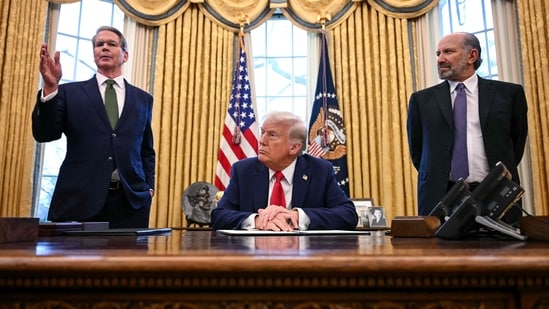 (L-R) US Secretary of Treasury Scott Bessent speaks as President Donald Trump and US Secretary of Commerce nominee Howard Lutnick look on after Trump signed an executive order to create a US sovereign wealth fund, in the Oval Office of the White House on February 3, 2025, in Washington, DC. (Photo by Jim WATSON / AFP) (AFP)
