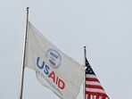A USAID and American flag fly before Congressional Democrats hold news conference outside of United States Agency (Photo by Mandel NGAN / AFP)