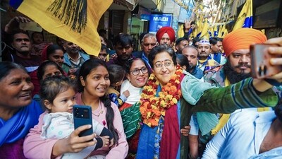 Delhi Chief Minister and AAP candidate from Kalkaji Assembly seat, Atishi takes a picture with women during an election campaign for the Delhi Assembly election, at Govindpuri in New Delhi. (Atishi - X)