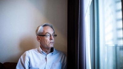 This file picture taken on February 6, 2020 shows former Nissan executive Greg Kelly posing at his apartment in Tokyo. (Behrouz Mehri/AFP)