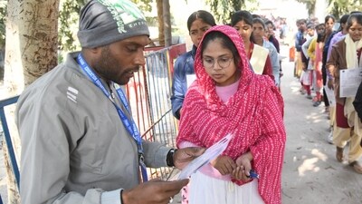 Officials checking the admit card details of candidates out the examination centre. (Santosh Kumar) Officials checking the admit card details of candidates out the examination centre. (Santosh Kumar)
