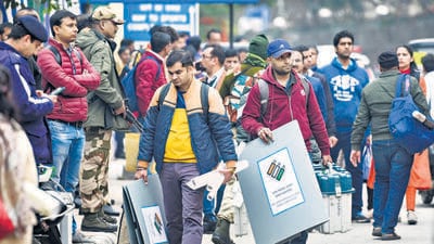 Polling officials with Electronic Voting Machines (EVM) and other devices ahead of the Delhi Assembly elections on Tuesday. (HT photo) Polling officials with Electronic Voting Machines (EVM) and other devices ahead of the Delhi Assembly elections on Tuesday. (HT photo)