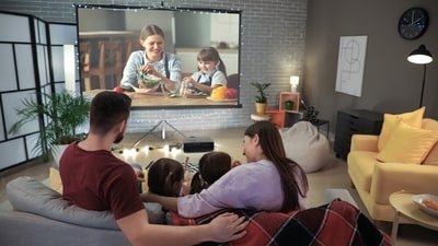 Create a cosy cinema-like atmosphere with a projector screen in your home. (Shutterstock) Create a cosy cinema-like atmosphere with a projector screen in your home. (Shutterstock)