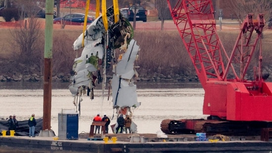 A large portion of the damaged plane fuselage is lifted from the Potomac River during recovery efforts after the American Airlines crash on February 03, 2025 in Arlington, Virginia (Photo by CHIP SOMODEVILLA / GETTY IMAGES NORTH AMERICA / Getty Images via AFP) (Getty Images via AFP)