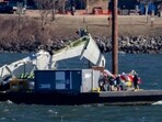 A piece of wreckage is lifted from the water onto a salvage vessel, near the site in the Potomac River of a mid-air collision between an American Airlines jet and a Black Hawk helicopter, at Ronald Reagan Washington National Airport, Tuesday, Feb. 4, 2025, in Arlington, A piece of wreckage is lifted from the water onto a salvage vessel, near the site in the Potomac River of a mid-air collision between an American Airlines jet and a Black Hawk helicopter, at Ronald Reagan Washington National Airport, Tuesday, Feb. 4, 2025, in Arlington,