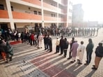 Voters wait in queues to cast their votes for the Delhi Assembly election at Karawal Nagar in New Delhi on February 5.