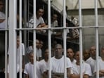 Inmates attend a class on social behavior from inside their shared cell during a press tour of the Terrorism Confinement Center, or CECOT, in Tecololuca, El Salvador, Oct. 12, 2023. (AP Photo/Salvador Melendez, File)