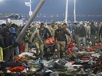 Security personnel carry an injured pilgrim at the site of a stampede amid the ongoing Maha Kumbh Mela festival in Prayagraj. (Arun Sankar/AFP)