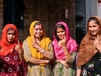 Pakistani Hindu refugees show their inked fingers after casting their votes for the first time in the Delhi Assembly elections at a resettlement colony in Majnu Ka Tila.