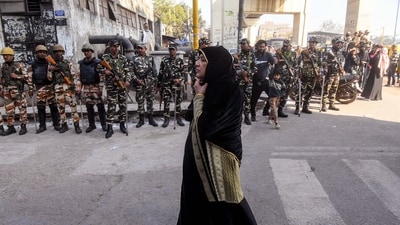 A voter walks past security personnel deployed at the Jafrabad polling station during the Delhi Assembly election in New Delhi on Wednesday. (ANI) A voter walks past security personnel deployed at the Jafrabad polling station during the Delhi Assembly election in New Delhi on Wednesday. (ANI)