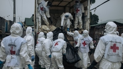 Members of the Congolese Red Cross and Civil Protection unload the bodies of the victims of the recent clashes to bury them in a cemetery in Goma. (AFP)
