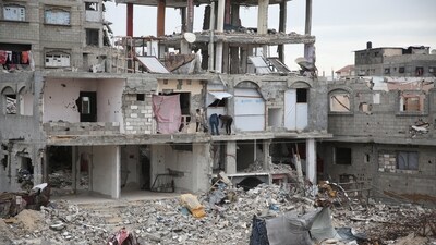 Palestinian children repair a portion of a building destroyed during the Israeli offensive, amid a ceasefire between Israel and Hamas, in Khan Younis in the southern Gaza Strip. (REUTERS)