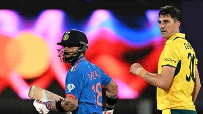 India's Virat Kohli (L) runs between the wickets past Australia's captain Pat Cummins (C) during an ODI match. (AFP)